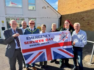 Cllr G Archer, Cllr M Cunningham, Mayor Dan Dunbar, Deputy Mayor Cllr S Shing, a member of East Sussex Fire and Rescue Service, a member of South East Coast Ambulance Service and Cllr D Watts proudly holding the Emergency Services Day flag outside of Polegate Town Council office.
