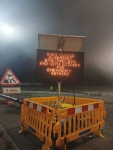 Roadworks sign saying: Road closed overnight, 6th/7th/8th and 11th October for emergency repairs
