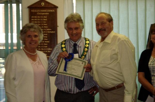 Mayor tim voyce presents a certificate to garden competition prize winners