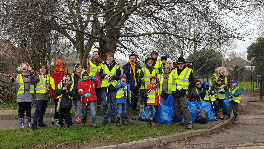 Group of children at litter pick day with parents