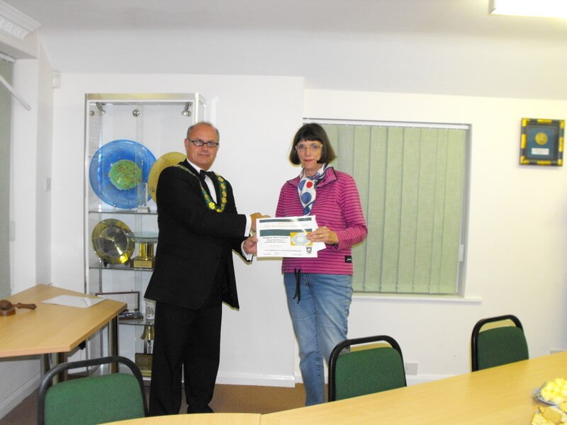 A lady resident is presented with a garden competition certificate by mayor Steve barber