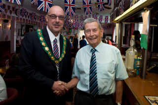 Mayor malcolm cunningham shakes hands with a royal british legion member