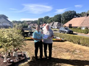 Certificate handed to resident from Town Mayor for special recognition
