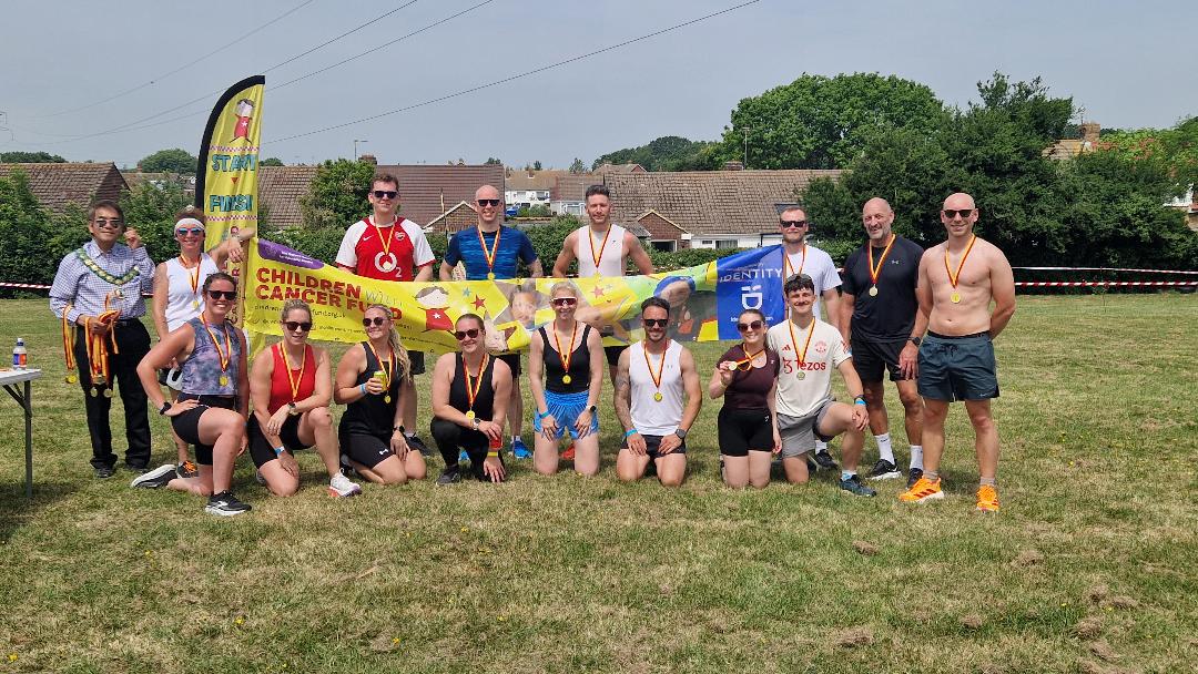 Mayor Shing stood with a large group of runners, wearing her medals