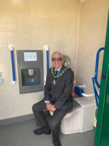 Cllr David Watts pictured inside the new public toilet