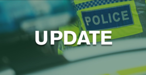 Photo with a police officer and the word update across the picture